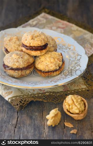 Homemade chip cookies with nuts filled with chocolate cream