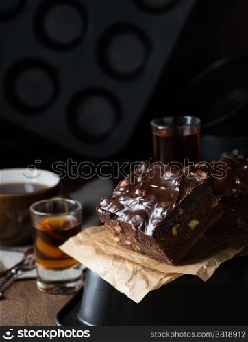 Homemade chocolate brownies with nuts and ganache, selective focus