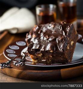 Homemade chocolate brownies with nuts and ganache, selective focus, closeup