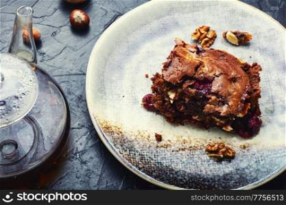 Homemade chocolate cake or brownie pie with cherries and nuts.. Marble cake with cherries and tea