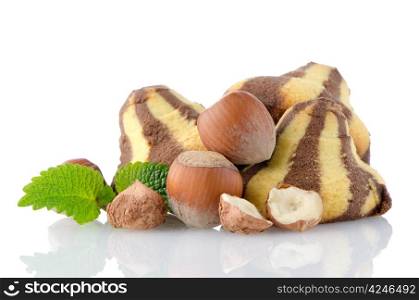 Homemade chocolate cookies and hazelnuts isolated on white background.