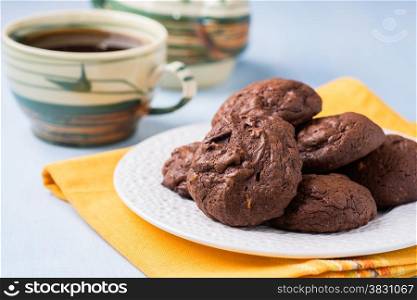 Homemade chocolate cookies on white plate, selective focus