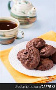Homemade chocolate cookies on white plate, selective focus