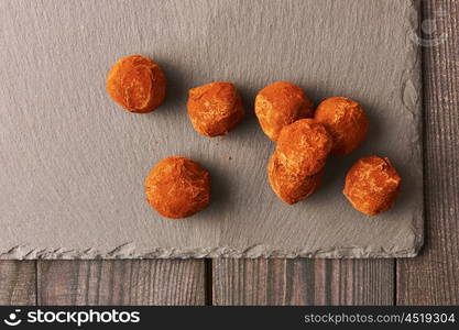 Homemade chocolate truffles on slate plate