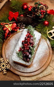 Homemade christmas cake with wild berries on woonen background. Homemade christmas cake with wild berries