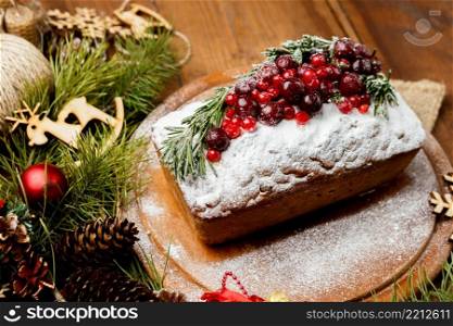 Homemade christmas cake with wild berries on woonen background. Homemade christmas cake with wild berries