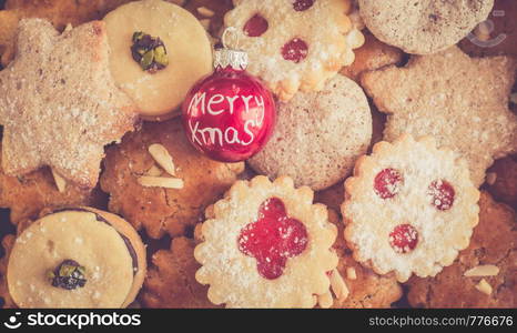 Homemade Christmas cookies and Christmas bauble on a rustic wooden table