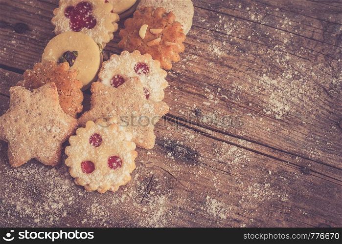 Homemade Christmas cookies and powdered sugar on a rustic wooden table