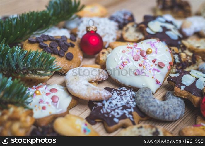 Homemade Christmas cookies, powdered sugar and Christmas bauble on a rustic wooden table