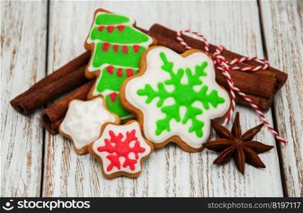 Homemade christmas cookies with cinnamon on wooden table