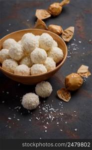 Homemade coconut candies on rustic table still life