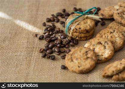 Homemade cookies and coffee beans on cray background