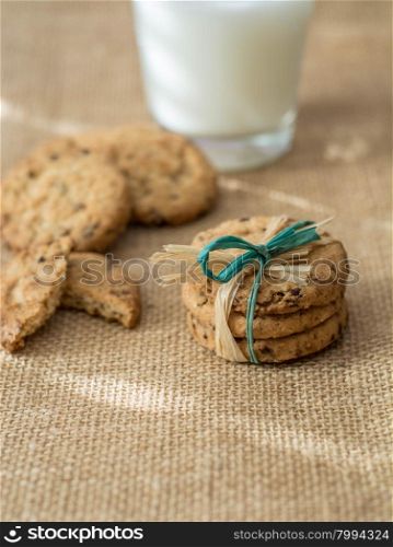 Homemade cookies,cinnamon and milk on gray background