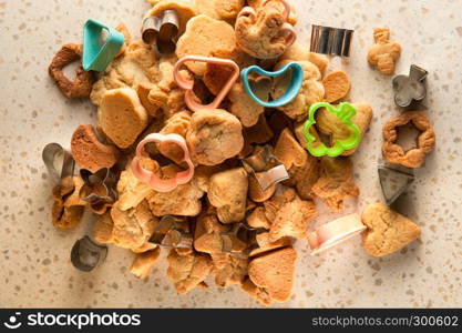 homemade cookies of various forms on a table with cookie cutter