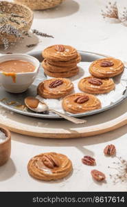 Homemade cookies with a generous dollop of Salted Caramel and pecan nut, sprinkled with crunchy sea salt flakes.