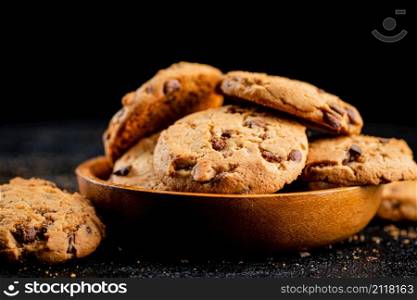 Homemade cookies with chocolate. Against a dark background. High quality photo. Homemade cookies with chocolate. Against a dark background