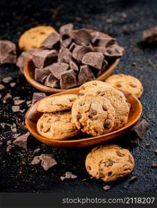 Homemade cookies with chocolate. Against a dark background. High quality photo. Homemade cookies with chocolate. Against a dark background