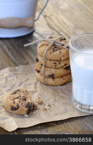 Homemade cookies with glass of milk on wooden table.