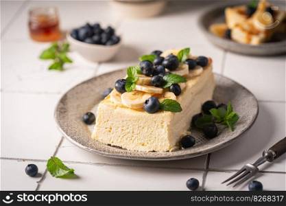 Homemade cottage cheese bake cake casserole with berries and banana on white background. Cottage cheese casserole