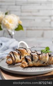 Homemade croissant served with black coffee or americano. Delicious breakfast with fresh croissant and coffee. Croissant and coffee for coffee break.