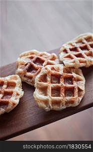 Homemade Croissant Waffle (Croffle) on wood background.. Homemade Croissant Waffle (Croffle)