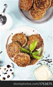 Homemade cutlets on a white plate and blue  background. Meat cutlets