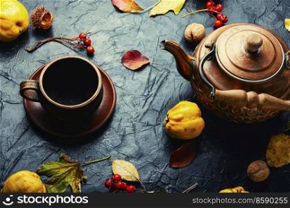 Homemade delicious fruit tea from autumn quince.. Quince tea and autumn leaves