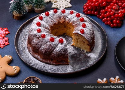 Homemade delicious round Christmas pie with red berries on a ceramic plate against a dark concrete background. Homemade delicious round Christmas pie with red berries on a ceramic plate