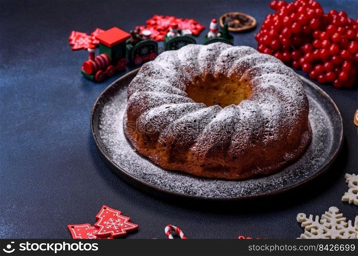 Homemade delicious round Christmas pie with red berries on a ceramic plate against a dark concrete background. Homemade delicious round Christmas pie with red berries on a ceramic plate
