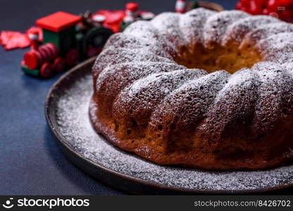 Homemade delicious round Christmas pie with red berries on a ceramic plate against a dark concrete background. Homemade delicious round Christmas pie with red berries on a ceramic plate