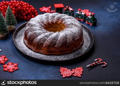 Homemade delicious round Christmas pie with red berries on a ceramic plate against a dark concrete background. Homemade delicious round Christmas pie with red berries on a ceramic plate