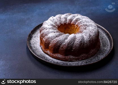 Homemade delicious round Christmas pie with red berries on a ceramic plate against a dark concrete background. Homemade delicious round Christmas pie with red berries on a ceramic plate