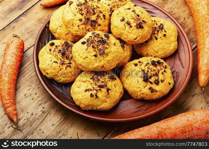 Homemade dietary carrot cookies, sweet pastries on wooden table. Vegan carrot cookies