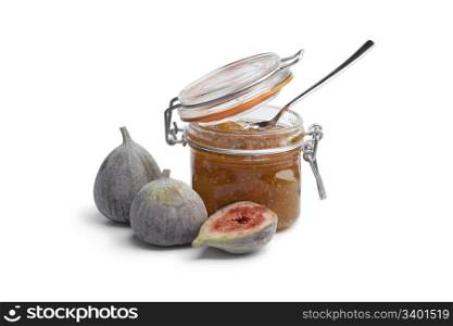 Homemade fig jam with fresh figs on white background