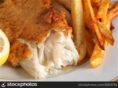 Homemade fish and chips served with a piece of lemon