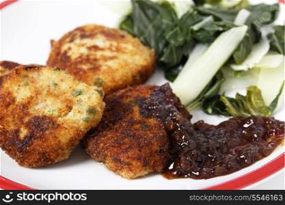 Homemade fishcakes and onion marmalade serves with boiled greens
