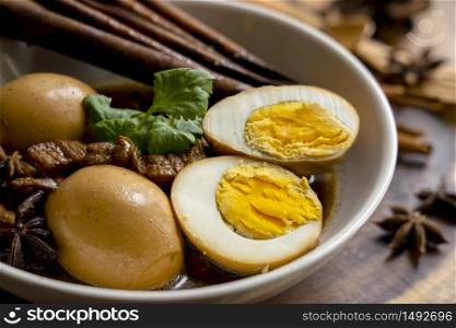 Homemade food, Stewed pork and Eggs with herb in sweet brown soup, Thai traditional food, Local or Street food favourite menu in Thailand. Thai name is Khai palo