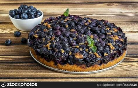 Homemade fresh-baked blueberry pie covered sugar powder