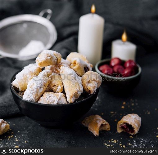 Homemade fresh cookies dusted powdered sugar in black plate