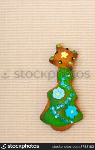 Homemade gingerbread cake christmas tree with icing and colorful decoration on brown. Holiday handmade concept.