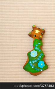 Homemade gingerbread cake christmas tree with icing and colorful decoration on brown. Holiday handmade concept.