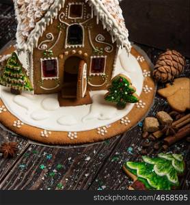 Homemade gingerbread house. Homemade gingerbread house on dark background, xmas theme