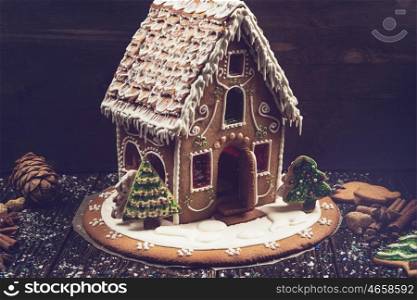 Homemade gingerbread house on dark background, xmas theme