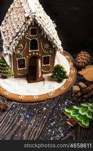 Homemade gingerbread house on dark background, xmas theme