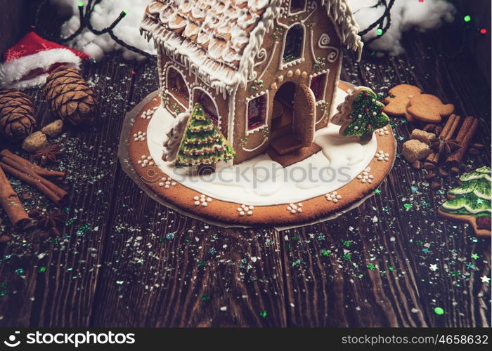 Homemade gingerbread house on dark background, xmas theme