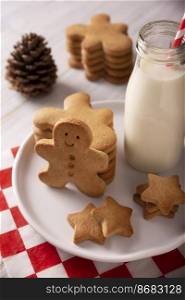 Homemade gingerbread man cookies and milk, traditionally made at Christmas and the holidays.