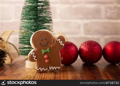 Homemade gingerbread men cookie on rustic wooden table, traditionally made at Christmas and the holidays.