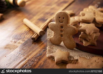 Homemade gingerbread men cookies and star shaped cookies, traditionally made at Christmas and the holidays. Closeup image.