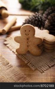 Homemade gingerbread men cookies cookies on rustic wooden table, traditionally made at Christmas and the holidays.