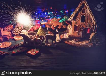 Homemade gingerbreads for new year holiday on dark wooden background, xmas theme